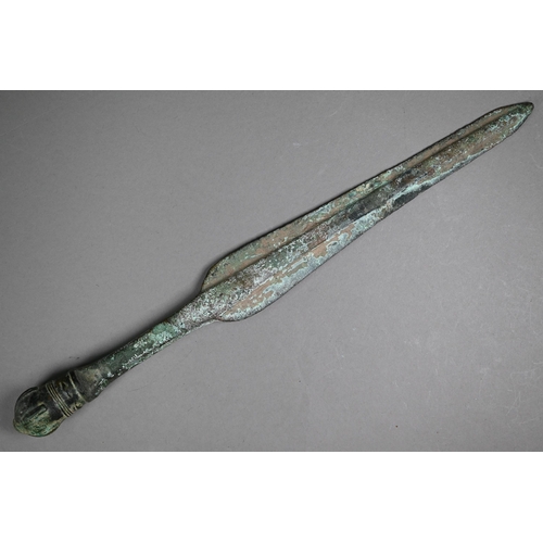 1102 - A Bronze Age shortsword, the shaped blade with thick raised midrib, with crown pommel, 41.5 cm long ... 