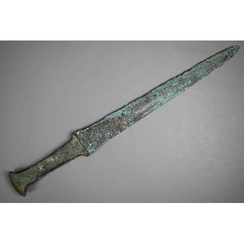 1103 - A Bronze Age (probably Iran) dagger, the tapering two-edge blade engraved with cruciform symbols and... 