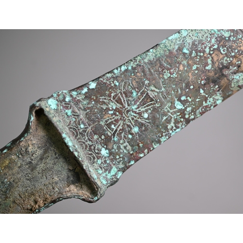 1103 - A Bronze Age (probably Iran) dagger, the tapering two-edge blade engraved with cruciform symbols and... 