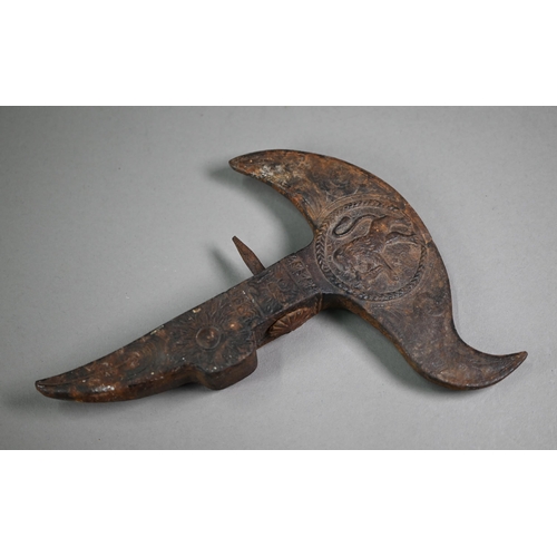 1106 - An antique iron ceremonial axe-head, the recurved blade cast with medallion of a mounted soldier, th... 