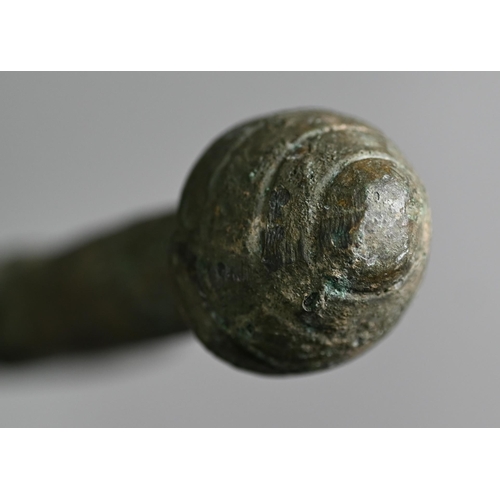 1107 - A Bronze Age sword, the tapering fullered blade with midrib, extending from oval shoulder, with colu... 