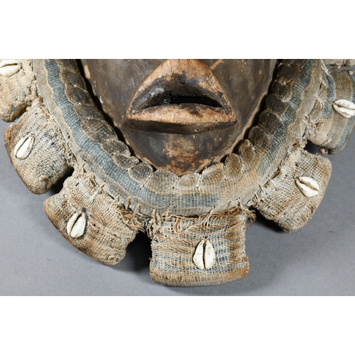 1112 - A West African Dan tribe mask, Deangle, Ivory Coast or Liberia, the carved oval stained hardwood fac... 