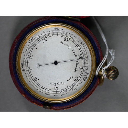 1125 - A 19th century gilt brass pocket barometer with 4.5 cm silvered dial in red morocco-bound case, to/w... 