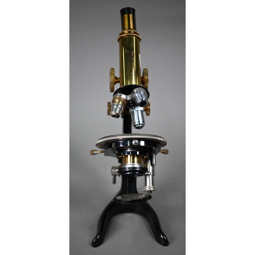 1127 - An Optca lacquered brass compound microscope with spare object lens and two spare subject lenses, 34... 