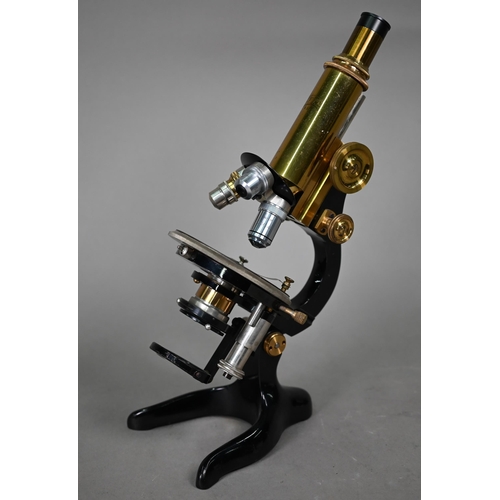 1127 - An Optca lacquered brass compound microscope with spare object lens and two spare subject lenses, 34... 