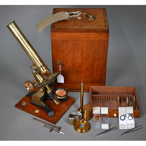 1130 - A vintage brass travelling microscope in box, with detachable platform lenses, slides etc by Franks ... 