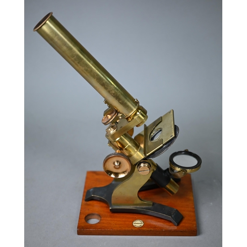 1130 - A vintage brass travelling microscope in box, with detachable platform lenses, slides etc by Franks ... 