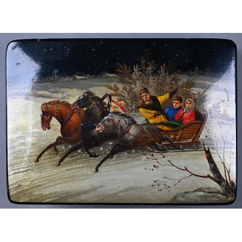 1137 - A Russian lacquered papier maché box, the hinged cover painted with a troika on a snowy road,... 