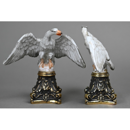 1140 - A pair of Continental porcelain spread eagle desk-ornaments, mounted on brass bases, 10.5 cm high