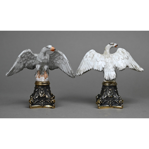 1140 - A pair of Continental porcelain spread eagle desk-ornaments, mounted on brass bases, 10.5 cm high