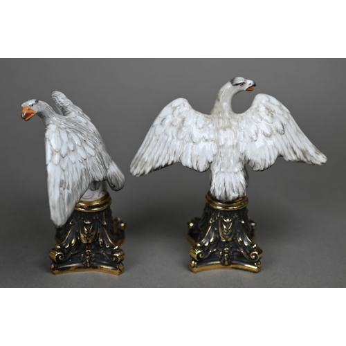 1140 - A pair of Continental porcelain spread eagle desk-ornaments, mounted on brass bases, 10.5 cm high