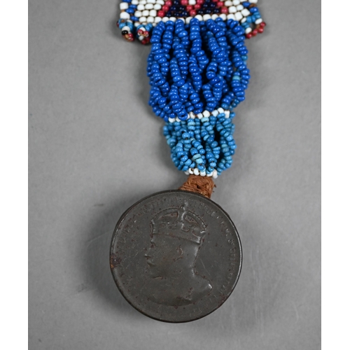 1146 - A Native American corncob doll with beadwork decoration, 19 cm high to/w a beadwork chest-ornament h... 