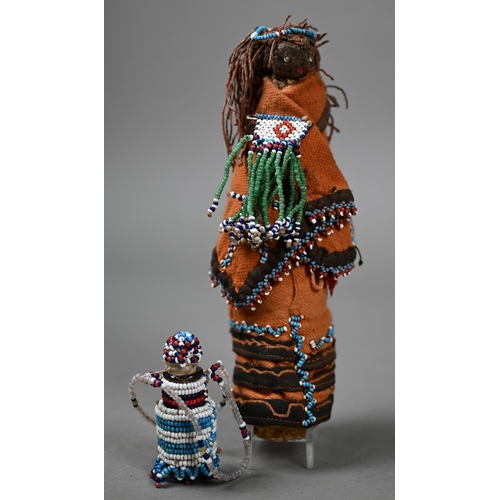 1146 - A Native American corncob doll with beadwork decoration, 19 cm high to/w a beadwork chest-ornament h... 