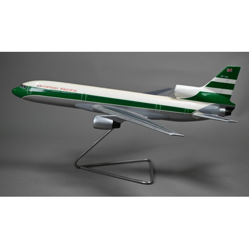 1175 - A painted wood model of a comercial air-liner with Cathay Pacific livery 55 cm long, on wire stand