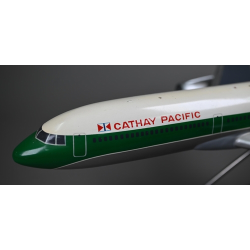 1175 - A painted wood model of a comercial air-liner with Cathay Pacific livery 55 cm long, on wire stand