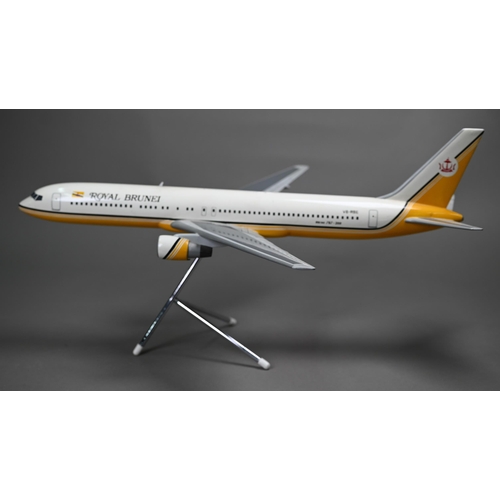 1176 - A painted wood model of a commercial air-liner in Royal Brunei livery 55 cm long on wire stand