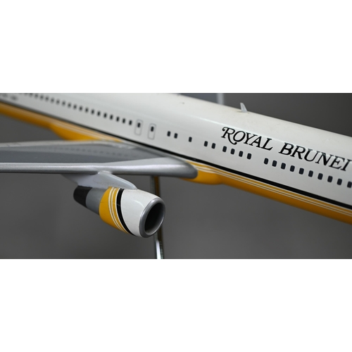 1176 - A painted wood model of a commercial air-liner in Royal Brunei livery 55 cm long on wire stand