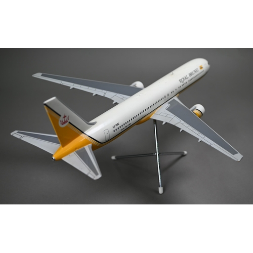 1176 - A painted wood model of a commercial air-liner in Royal Brunei livery 55 cm long on wire stand