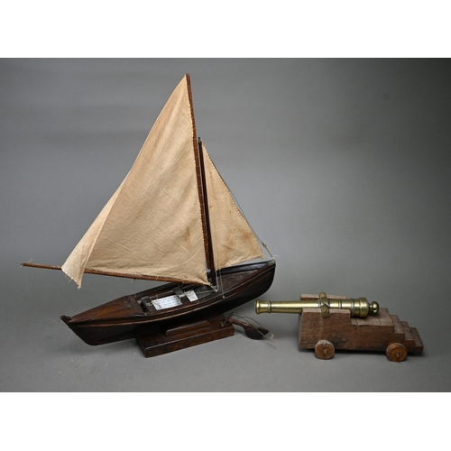 1179 - A model sailing dinghy, with card inscribed 'Model of Malay 'Dukone' made by Dick the Malay Pilot, C... 