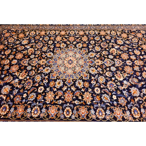 1201 - Central Persian signed Kashan carpet, predominantly blue centred by a floral medallion, 380 x 270 cm