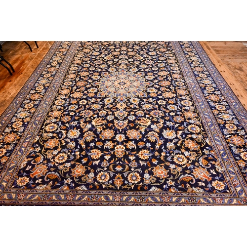 1201 - Central Persian signed Kashan carpet, predominantly blue centred by a floral medallion, 380 x 270 cm