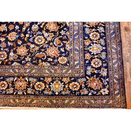 1201 - Central Persian signed Kashan carpet, predominantly blue centred by a floral medallion, 380 x 270 cm