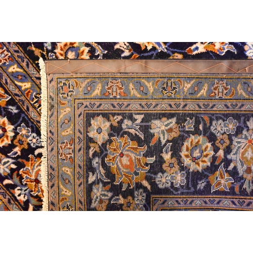 1201 - Central Persian signed Kashan carpet, predominantly blue centred by a floral medallion, 380 x 270 cm