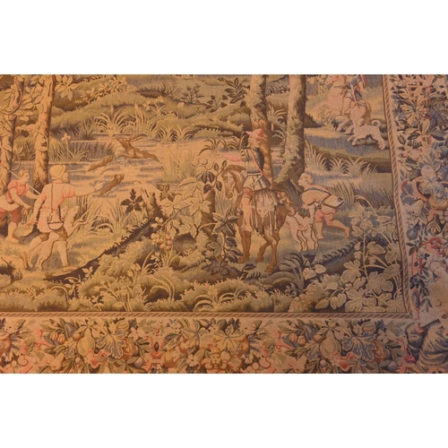 1202 - A vintage Renaissance style tapestry wall-hanging, centred by a deer-stalking party in a pastoral va... 