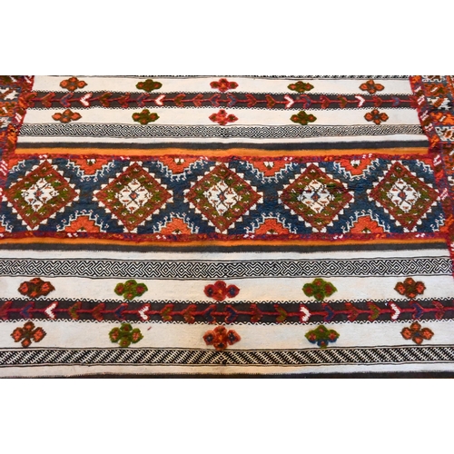 1209 - A Mid-Century Moroccan kelim panelled rug of multi-coloured geometric symbols on predominantly camel... 