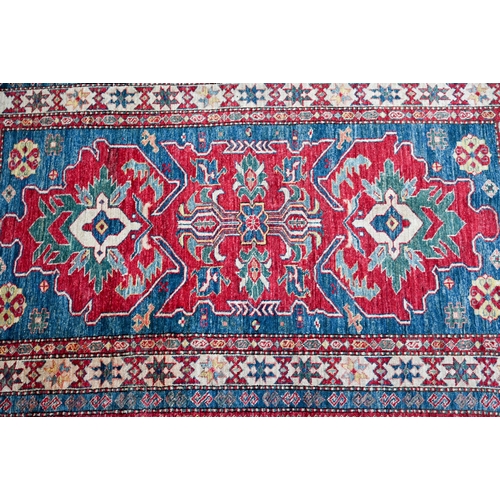 1211 - A contemporary Kazak rug, triple lozenge design on mid blue/red ground, 190 x 118 cm