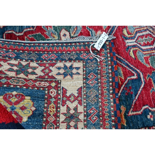 1211 - A contemporary Kazak rug, triple lozenge design on mid blue/red ground, 190 x 118 cm