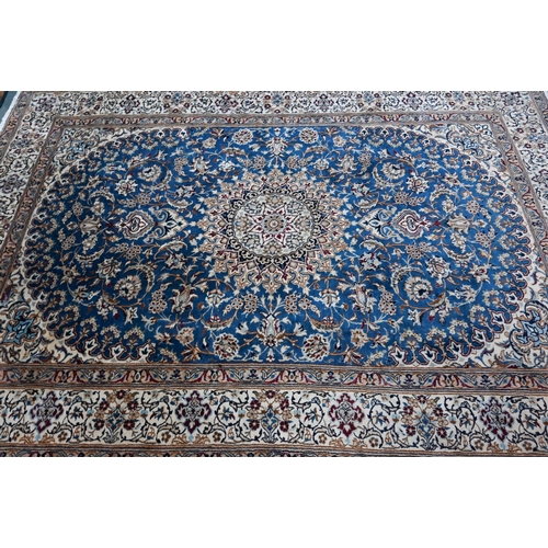 1215 - A Central Persian part silk Nain carpet with mid-blue ground centred by radiating floral medallion, ... 