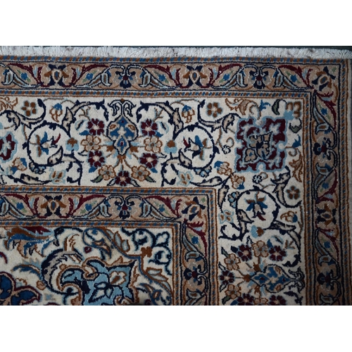 1215 - A Central Persian part silk Nain carpet with mid-blue ground centred by radiating floral medallion, ... 