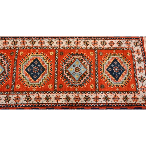 1218 - A contemporary Indo-Persian Kazak runner, burnt orange ground with five alternating lozenge design, ... 