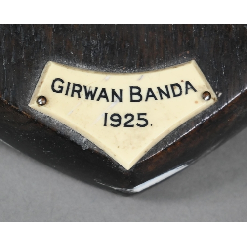 1243 - Taxidermy - A leopard's head trophy on wooden shield with plaque inscribed 'Girwan Banda 1925'