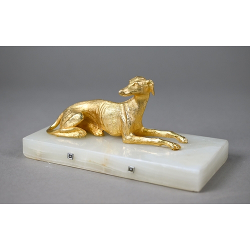 1246 - A gilt metal recumbant lurcher, on onyx base, 18 cm wide overall