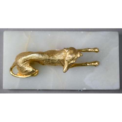 1246 - A gilt metal recumbant lurcher, on onyx base, 18 cm wide overall