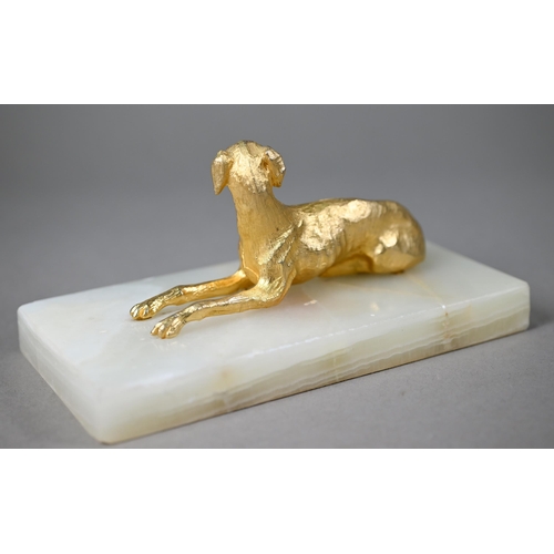 1246 - A gilt metal recumbant lurcher, on onyx base, 18 cm wide overall