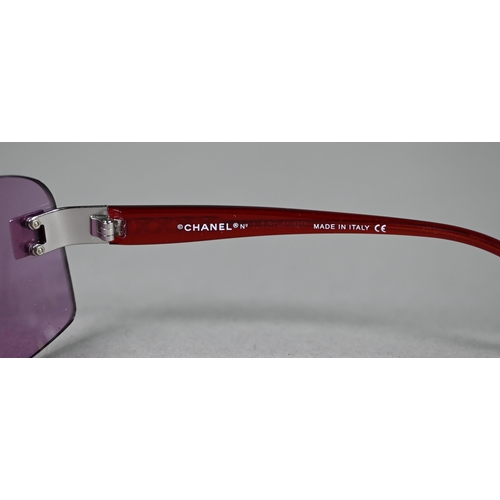 1275 - A cased pair of Chanel sunglasses with amethyst-shaded lenses