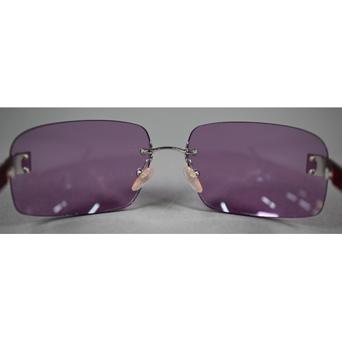 1275 - A cased pair of Chanel sunglasses with amethyst-shaded lenses