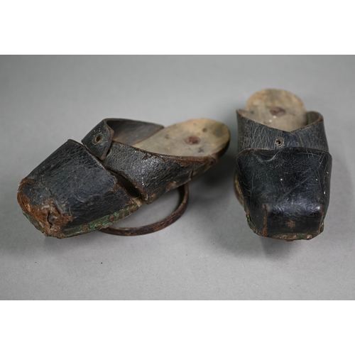 1277 - A pair of early 18th century children's leather pattens/overshoes, wooden soles raised by iron rings... 