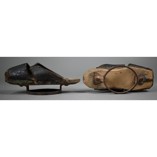 1277 - A pair of early 18th century children's leather pattens/overshoes, wooden soles raised by iron rings... 