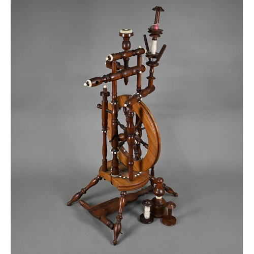 832 - An antique turned wood small spinning wheel with bone-mounts, 73 cm overall