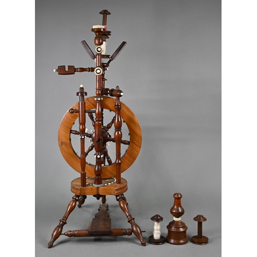 832 - An antique turned wood small spinning wheel with bone-mounts, 73 cm overall