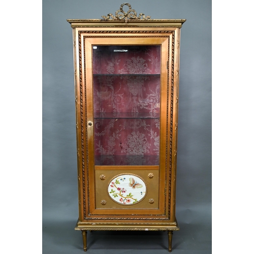 844 - A Napoleon III style giltwood three quarter glazed display cabinet surmounted by a ribbon bow mouldi... 