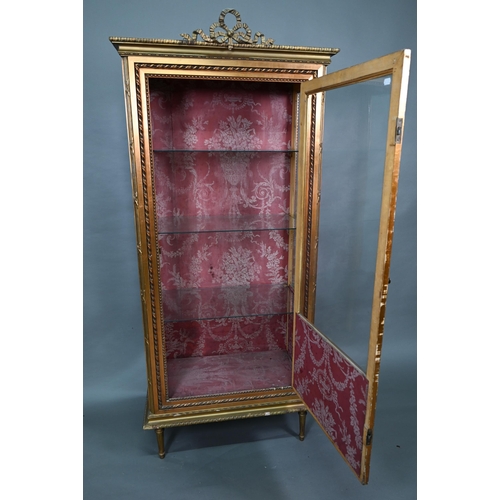 844 - A Napoleon III style giltwood three quarter glazed display cabinet surmounted by a ribbon bow mouldi... 