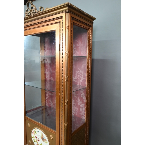 844 - A Napoleon III style giltwood three quarter glazed display cabinet surmounted by a ribbon bow mouldi... 