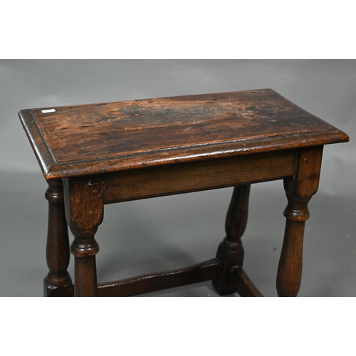 845 - A 17th century style elm joint stool, on turned supports, 53 cm x 27 cm x 50 cm h