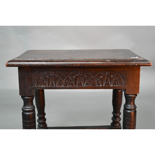 847 - A 17th century style oak joint stool, the single plank seat over a lunette carved frieze, 45 cm x 27... 