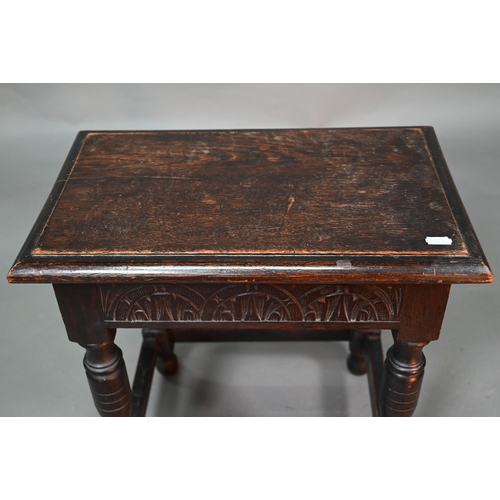 847 - A 17th century style oak joint stool, the single plank seat over a lunette carved frieze, 45 cm x 27... 